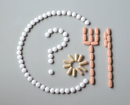 nutrient-additives-medicine-pills-bless-you-47073-47073 Artistic layout of various pills forming a question mark with fork and sun.