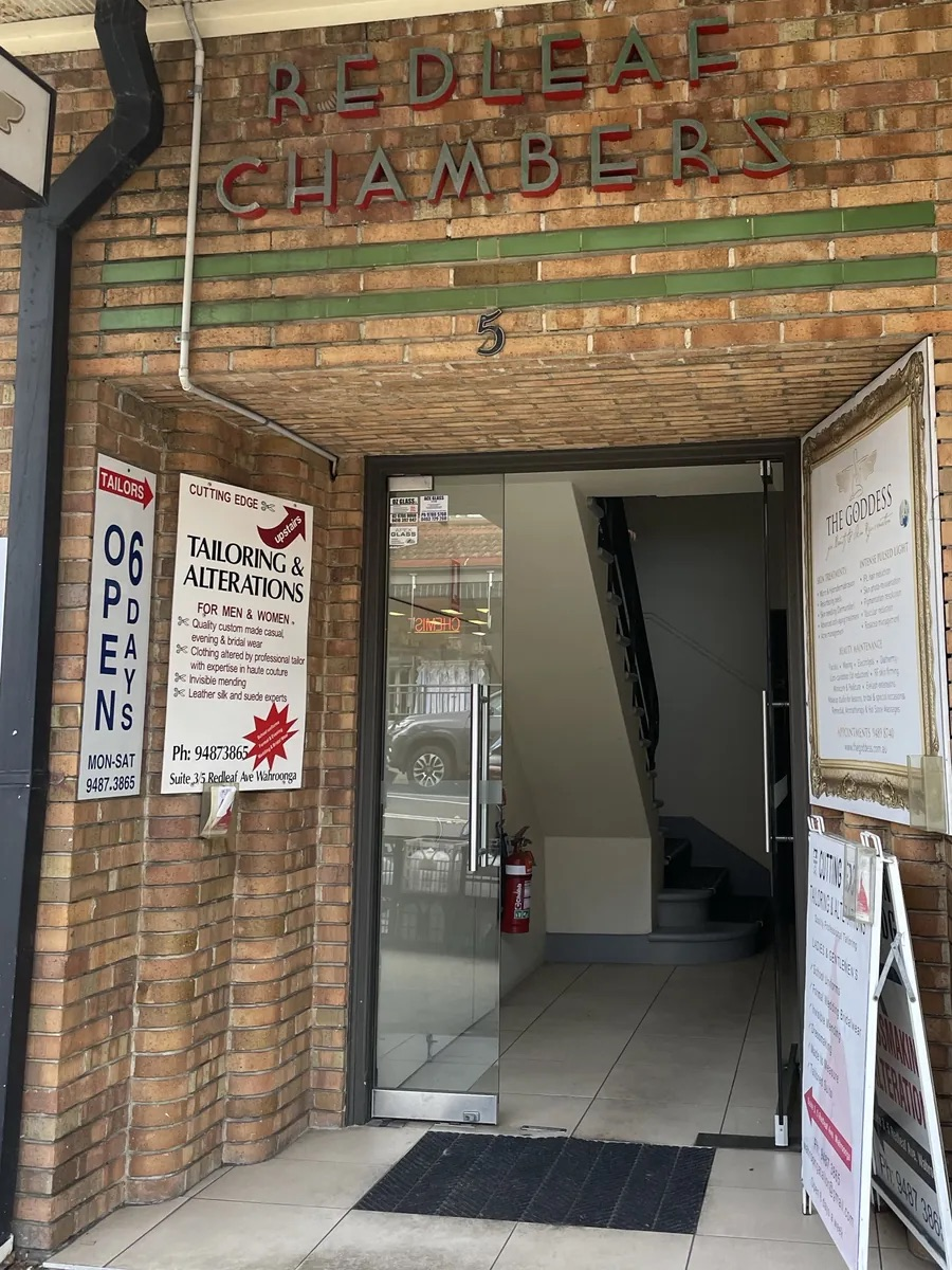 The glass-door entrance to Redleaf Chambers at 5 Redleaf Avenue, Wahroonga, with stairs leading up inside